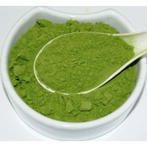Barley Grass Powder Herba Organica in a ceramic bowl showing vibrant green, finely ground powdered herb