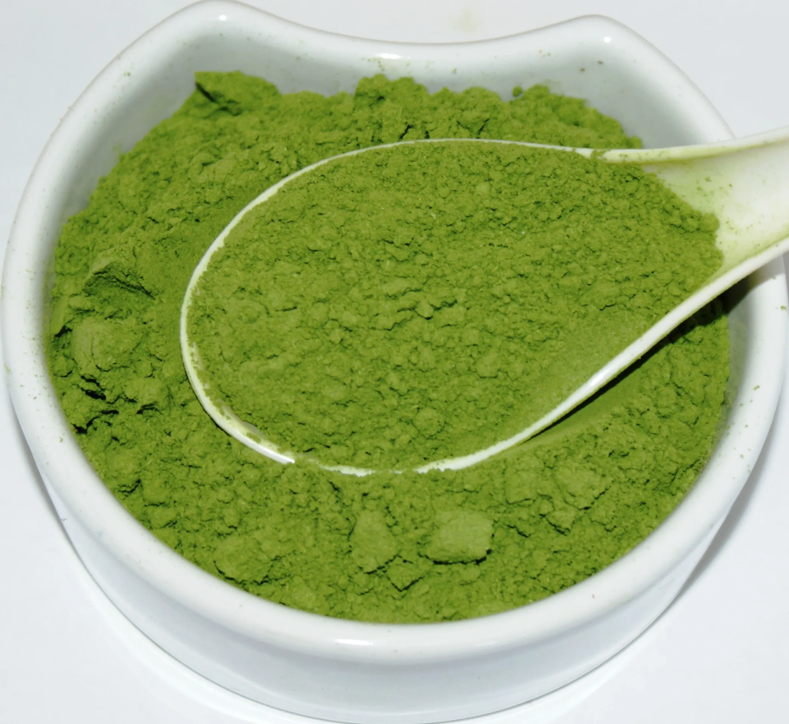 Barley Grass Powder Herba Organica in a ceramic bowl showing vibrant green, finely ground powdered herb