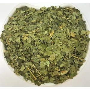 Black Currant Leaf Herba Organica in a ceramic bowl showing dried leaves with natural texture and deep green tones.